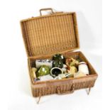 A vintage wicker picnic basket containing a quantity of mixed ceramics, to include Dartmouth bowl,