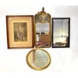 A French-style gilt framed wall mirror surmounted by a print of a couple feeding each other