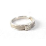 A white metal dress ring set with small diamond, size K.