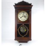 An early 20th century oak cased regulator wall clock, the silvered dial set with Arabic numerals,