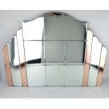 An Art Deco shaped clear and copper toned panelled wall mirror, the central section of six bevel