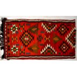 An Iraqi Bedu red ground hand woven Kilim runner, 438 x 110cm438 x 110cm