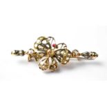 A yellow metal rope twist bar brooch with central butterfly set with rose cut diamonds and red stone