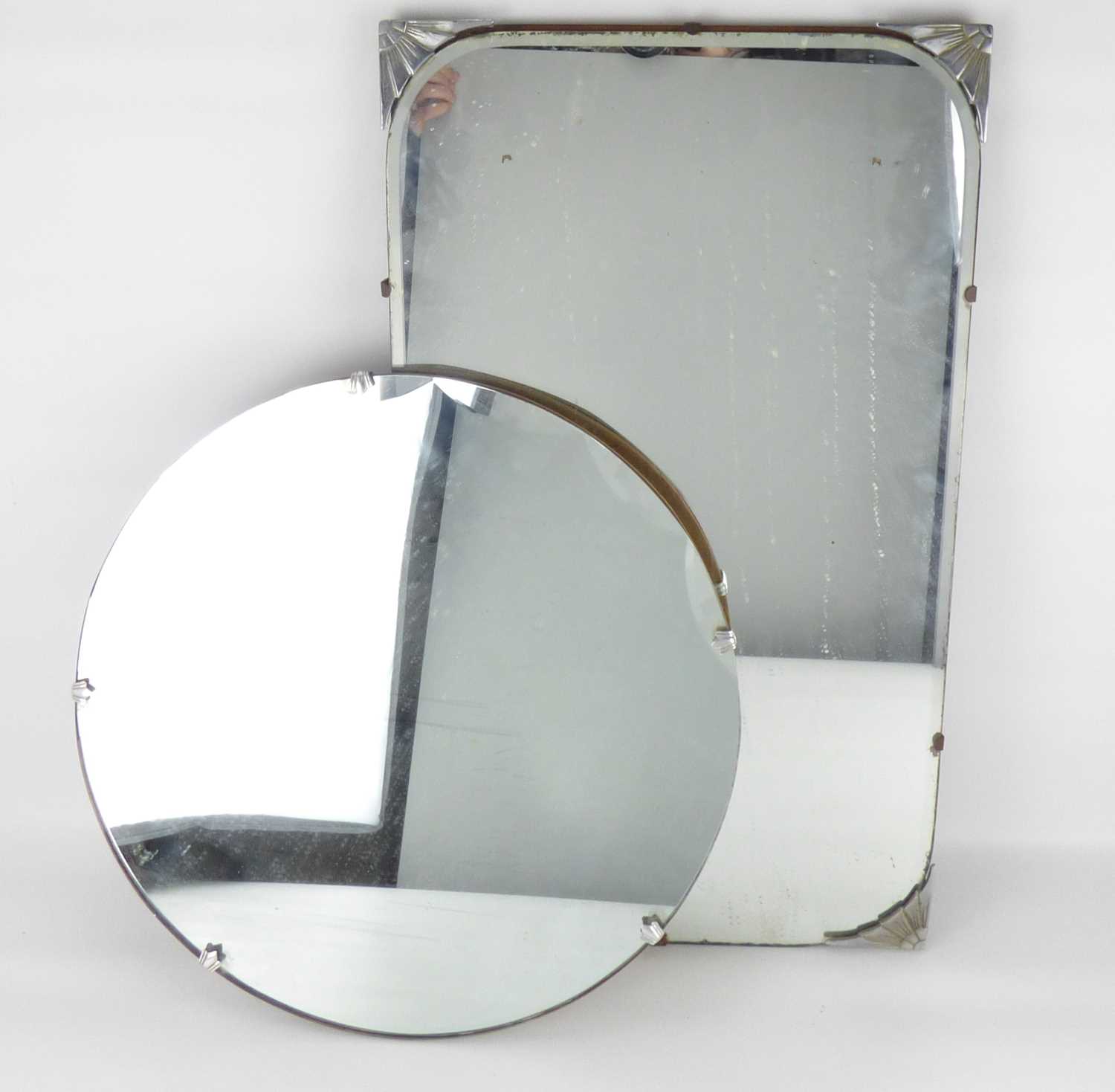 Two Art Deco wall mirrors, one with chrome Art Deco sunburst corner brackets and shaped