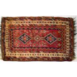 An Iranian Shiraz red ground hand knotted rug, 225 x 150cm.225 x 150cmCondition Report; several