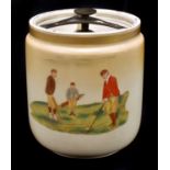 CARLTONWARE; a tobacco jar and cover decorated with figures golfing, one side decorated with the