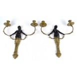 A pair of decorative modern twin branch candle holders representing blackamoor style maiden