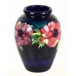 WALTER MOORCROFT; a shouldered vase decorated in 'Anemone' pattern on a blue ground, blue