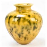 A contemporary pottery vase decorated with a mottled yellow and brown glaze, incised monogram,