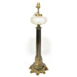 A Gothic inspired brass oil lamp with clear cut glass reservoir, cluster central column to a