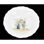 MEISSEN; a nursery plate decorated with two children picking fruit, cancelled cross swords mark to