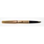 PARKER; a 9ct gold cased fountain pen with engine turned decoration surrounding rectangular