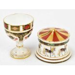 ROYAL CROWN DERBY; a Treasures of Childhood carousel money box, diameter 11.5cm, with a 1128 pattern