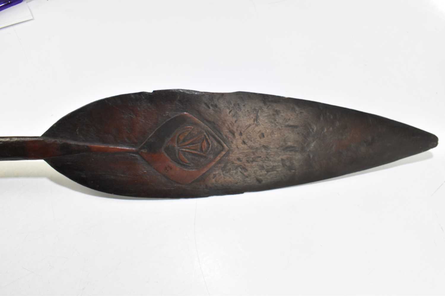 A late 19th/early 20th century hardwood tribal paddle with the detail of a stylised face to one side - Image 2 of 6