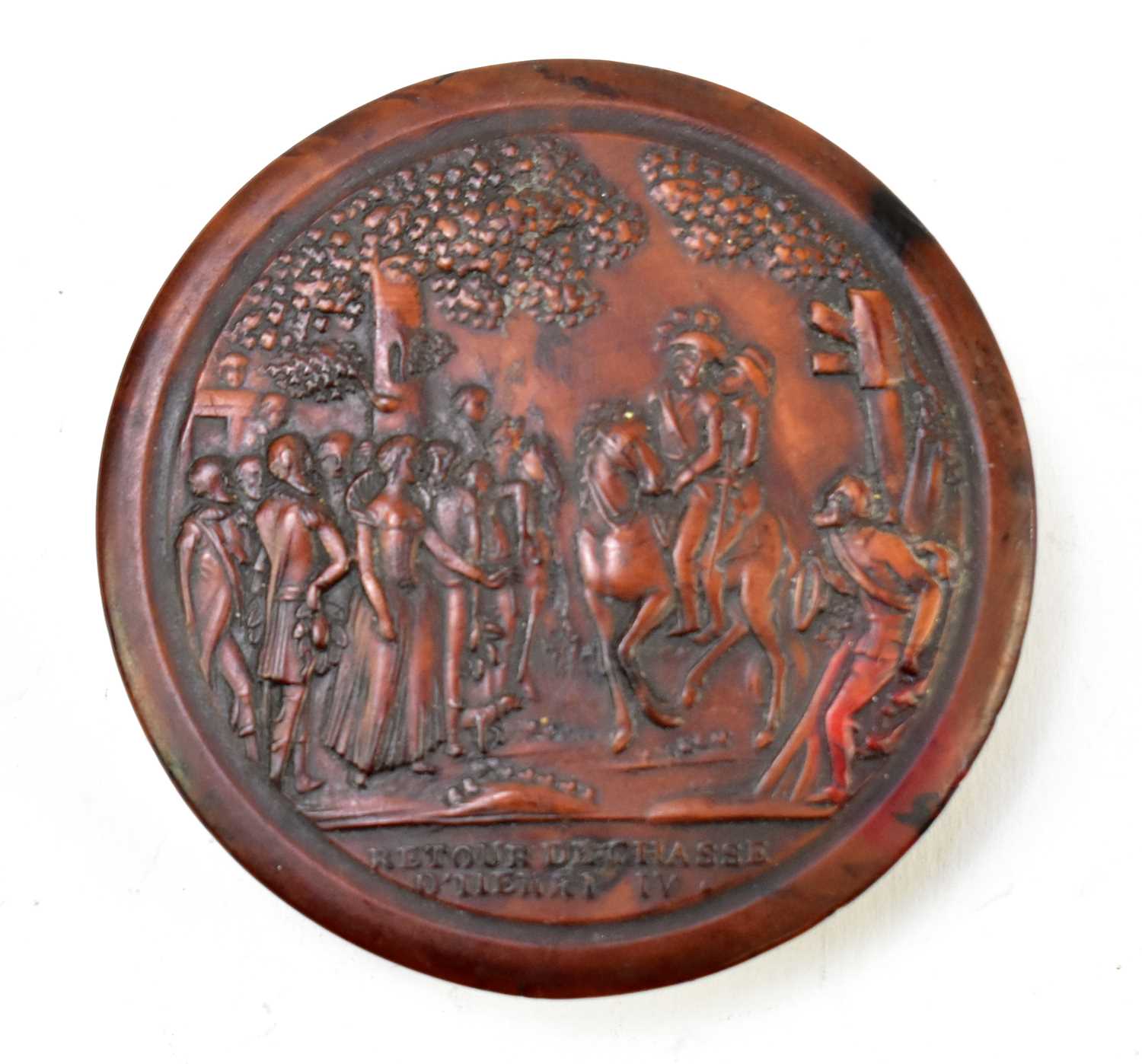A 19th century French burr wood snuff box of circular form embossed with figures on horseback,