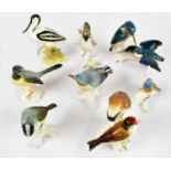 KARL ENZ; eight ceramic bird sculptures including two kingfishers perching on a branch, length 15cm,