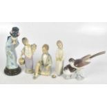 LLADRO; a collection of four ceramic figures including a geisha, tallest 26cm, with a Lladro group