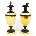 A pair of decorative alabaster and bronzed metal table lamps with moulded floral decoration,