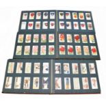 Three cigarette card albums containing a selection of cigarette and tea cards including Will's