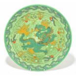 CHARLOTTE RHEAD FOR CROWN DUCAL; a circular ceramic charger decorated with a dragon, diameter 32cm.