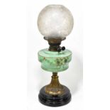 A Victorian oil lamp, the clear frosted glass shade above the opaque glass reservoir with painted