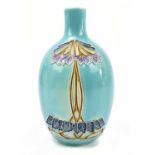 An early 20th century Austrian Art Nouveau vase with stylised tube lined decoration on a turquoise