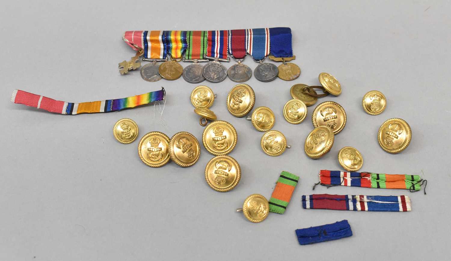 A miniature medal group, comprising eight medals and a group of various buttons and ribbon bars.