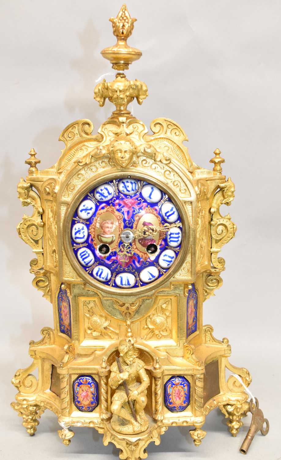A late 19th century French ormolu mantel clock with enamel dial and inset enamel panels, height