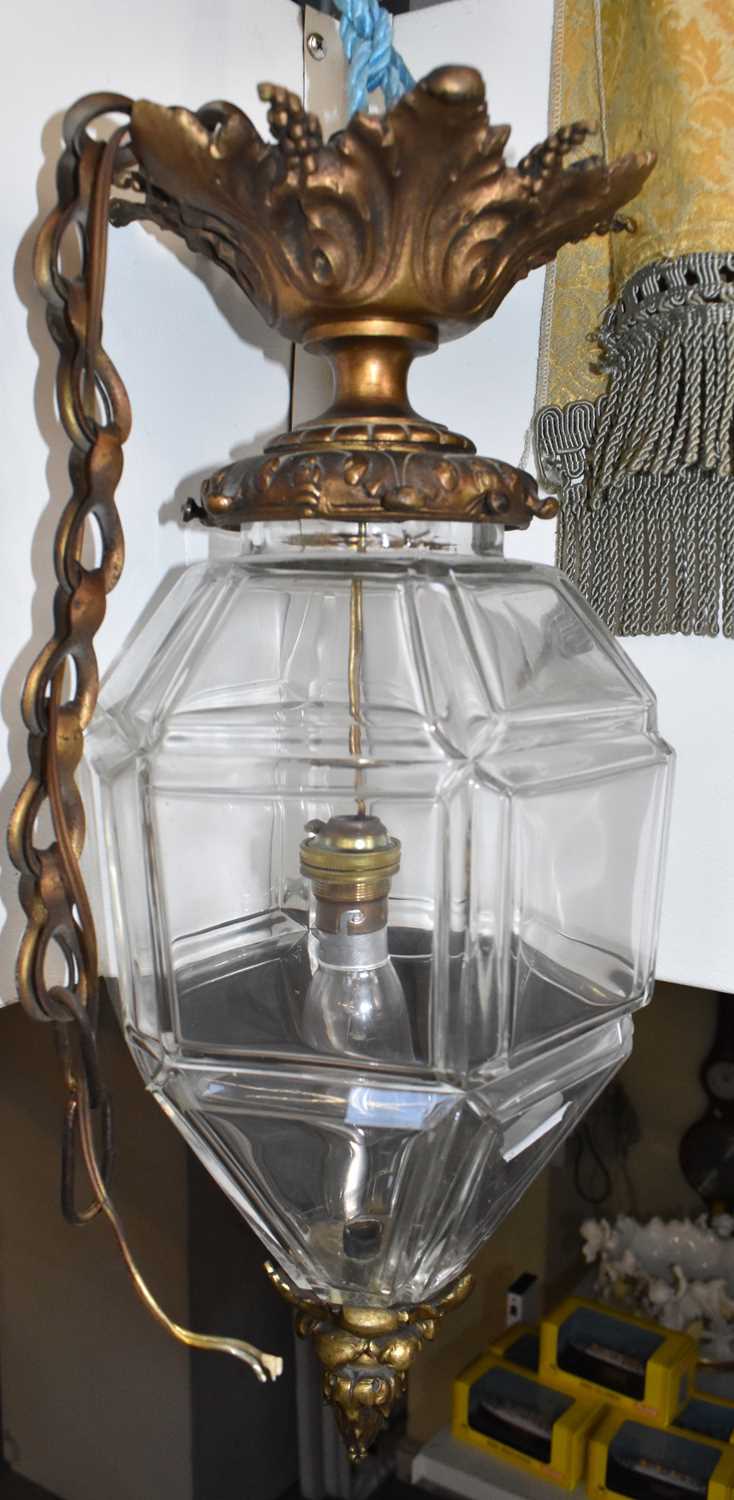 A hexagonal glass ceiling light with gilt metal mounts, another of hexagonal pointed form, and a