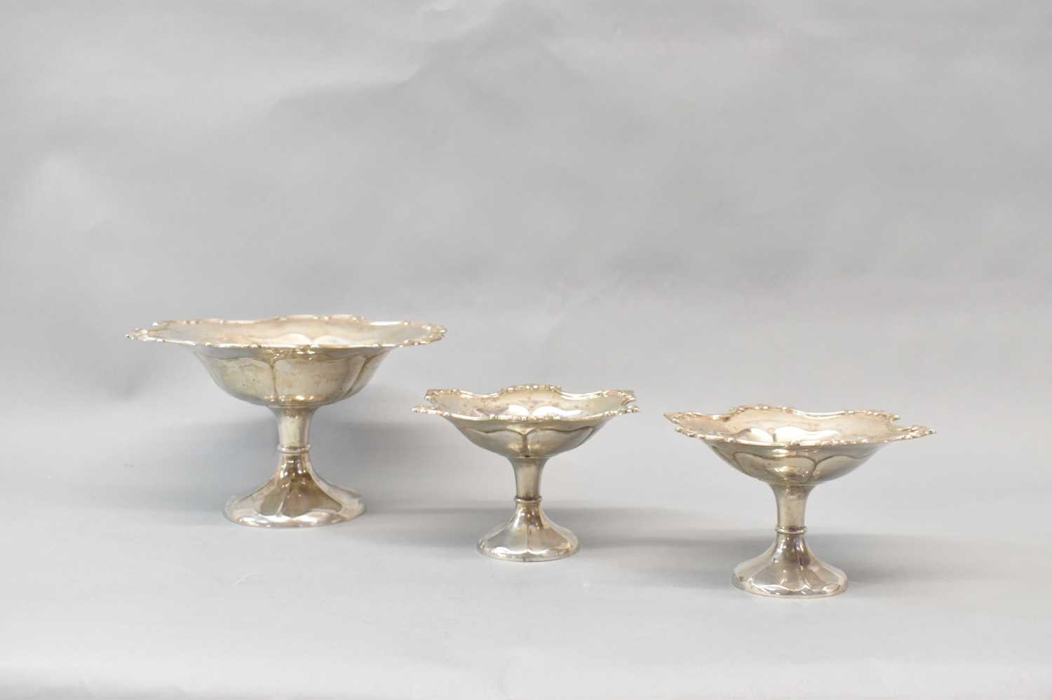 HORACE WOODWARD & CO LTD; a set of three Edward VII hallmarked silver comports, London 1906, the