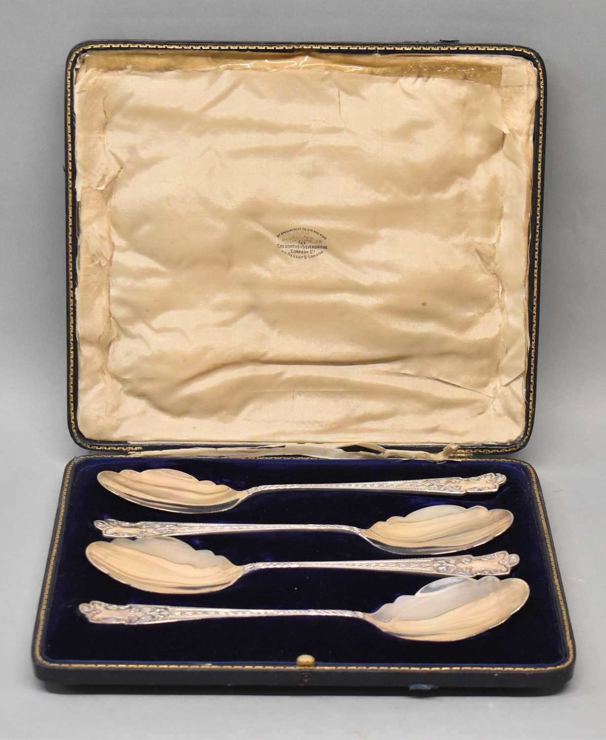 GOLDSMITHS & SILVERSMITHS CO LTD; a cased set of four George V hallmarked silver serving spoons,