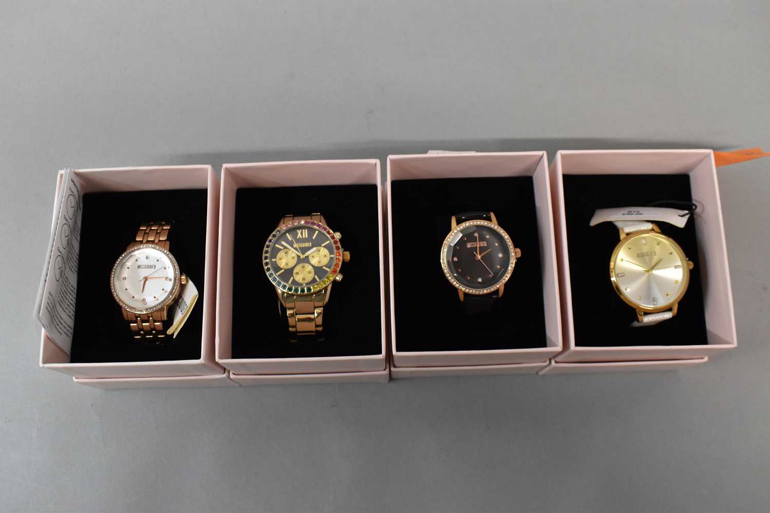 MISGUIDED; four lady's wristwatches, three with diamante bezels, in original boxes (4).