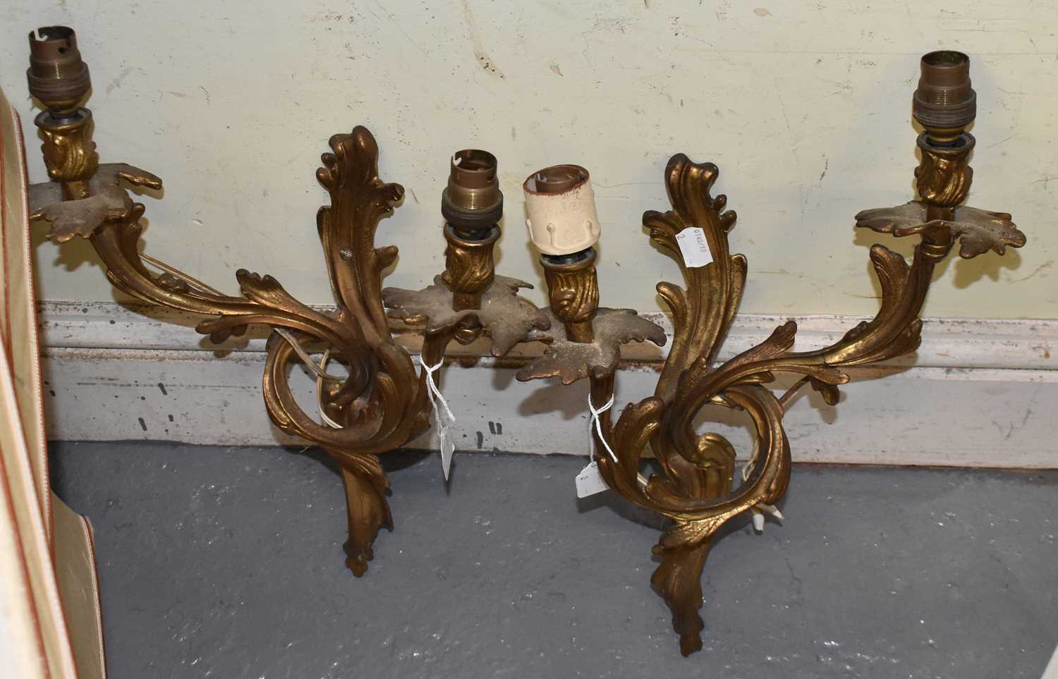 A pair of gilt metal Rococo style two branch wall lights, height 33cm.