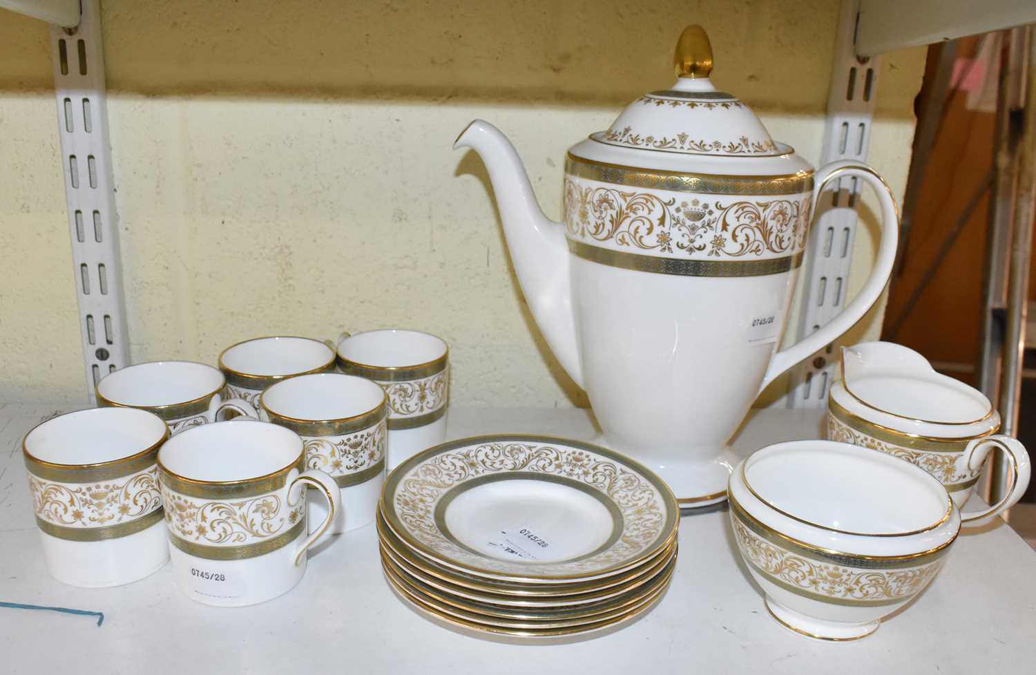 A Minton 'Aragon' six setting coffee service comprising coffee pot, six cups and saucers, cream