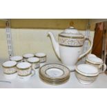 A Minton 'Aragon' six setting coffee service comprising coffee pot, six cups and saucers, cream