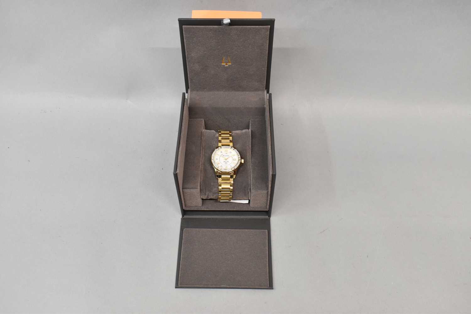BULOVA; a lady's wristwatch with stainless steel and gold bracelet with diamond bezel and mother