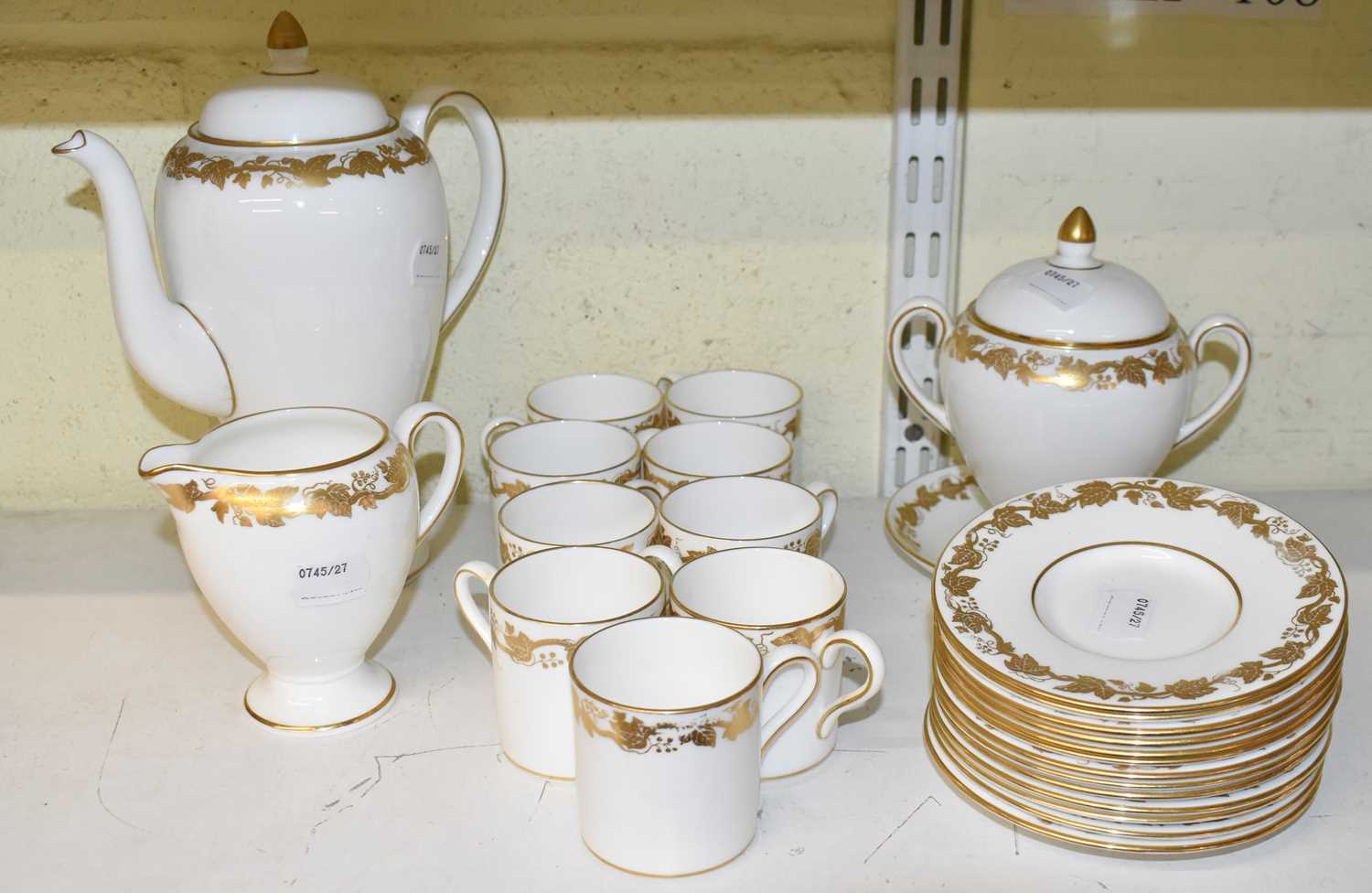 A Wedgwood 'Whitehall' part coffee service comprising nine cups, coffee pot, thirteen saucers, sugar