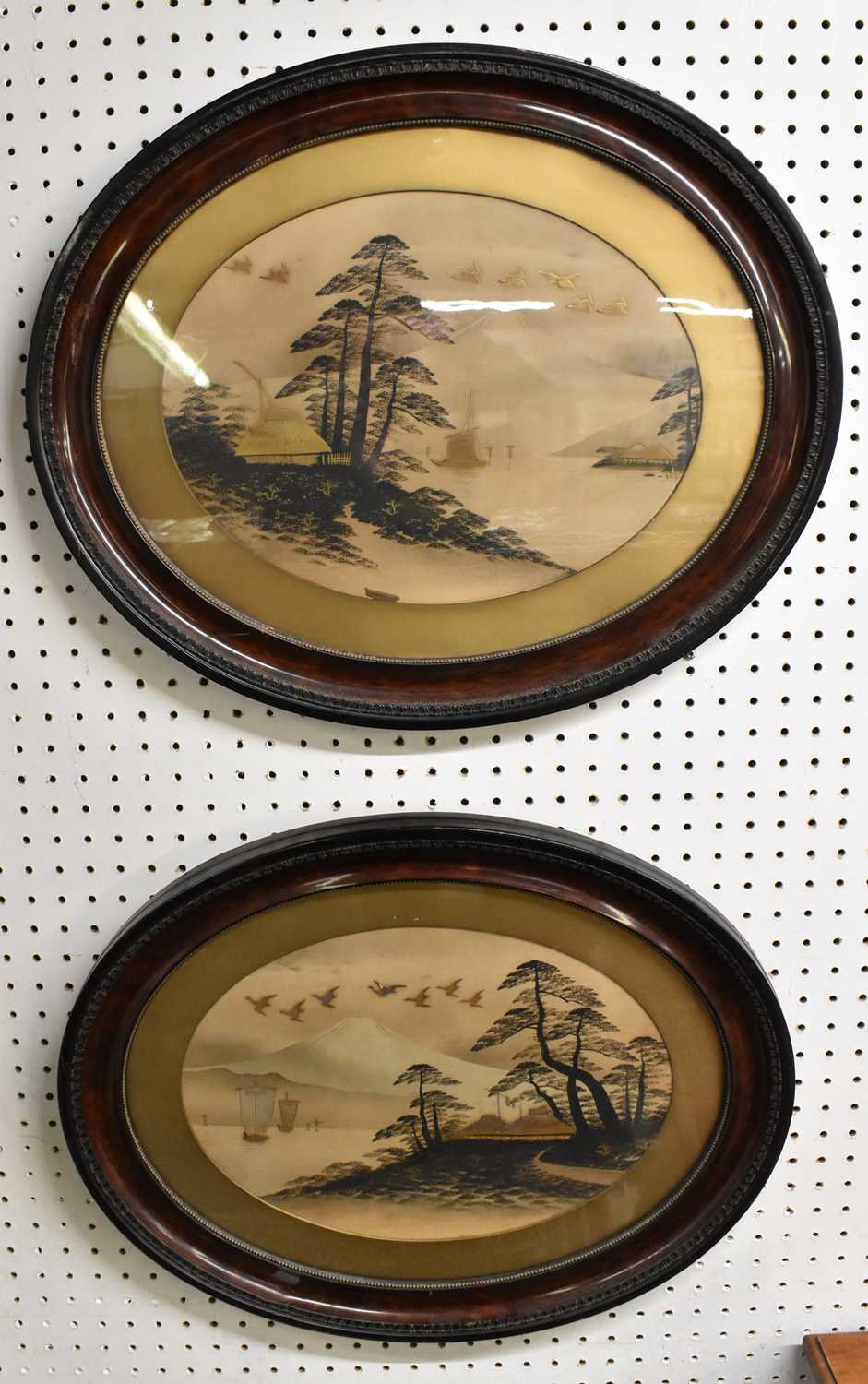 A pair of early 20th century Japanese prints with gilt highlights, each depicting scenes of Mount