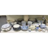 A shelf of predominantly modern Chinese style blue and white ceramics, also a tall Blanc de Chine