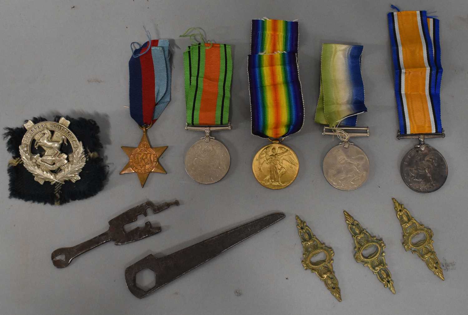 Two World War I medals to Cpl H Sherrington, Liverpool Regiment, a Liverpool Scottish cap badge,