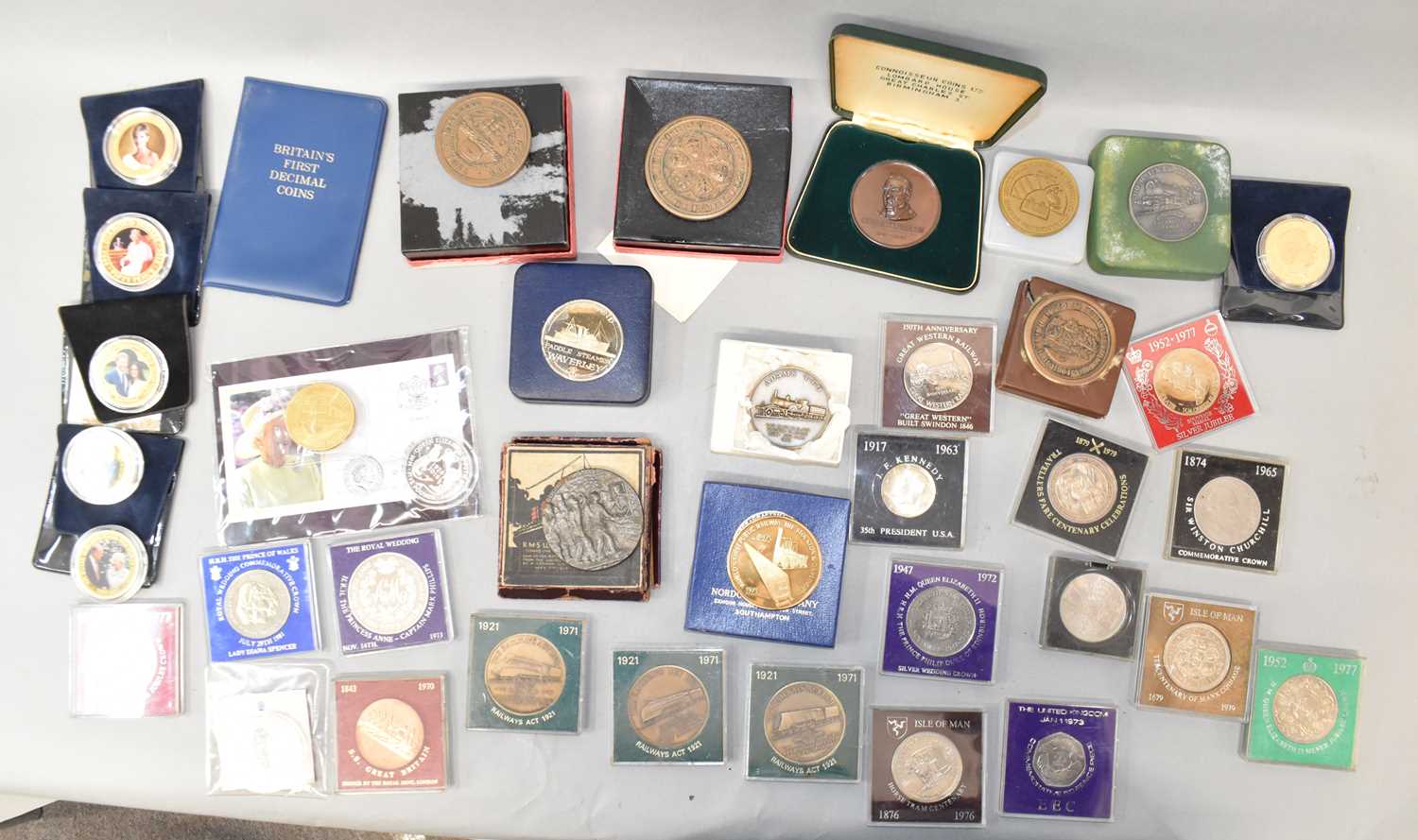 A collection of mainly commemorative coins and crowns, also various railway medallions, a boxed