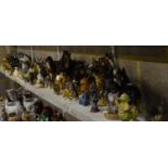 Four shelves of assorted animal figures including six Shire horses, German Shepherd figures,