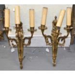 A pair of gilt metal urns, and swag decorated three branch wall lights, height 37cm.