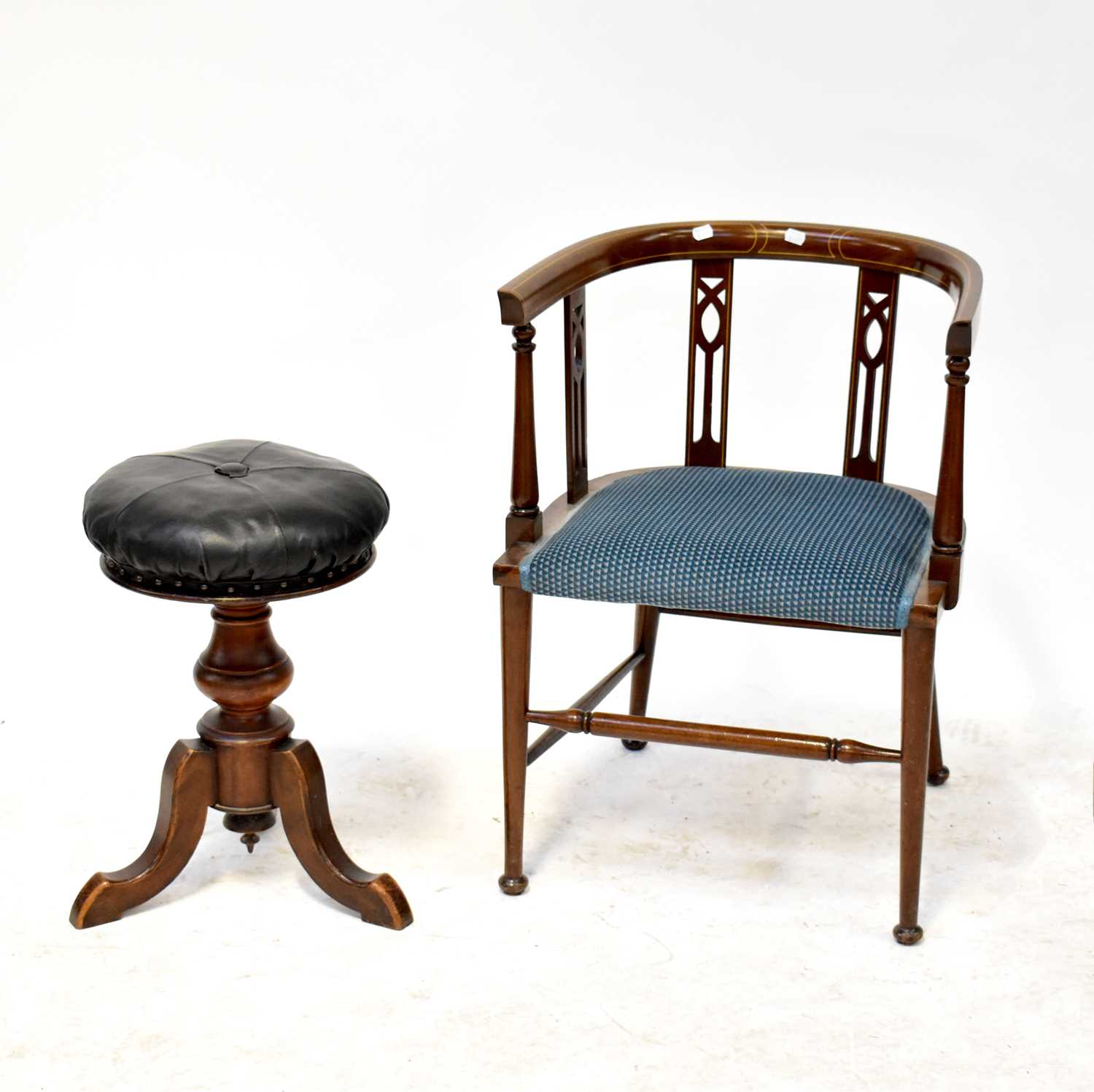 A Victorian piano stool with leather button top and adjustable seat height, on tripod base, together