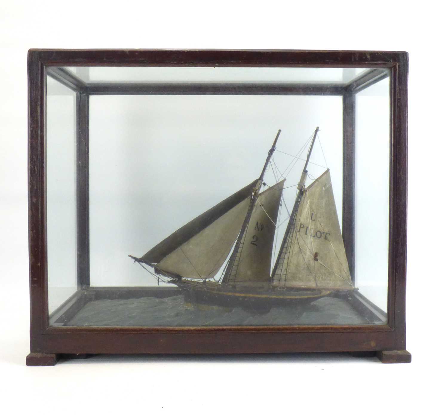 A late 19th/early 20th century wooden model of a two-masted sailboat with 'No.2' to one sail, the