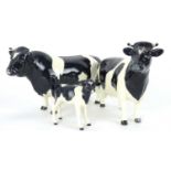 A Friesian cow family comprising bull, cow and calf (each af).Qty: 3Each with some form of repair.