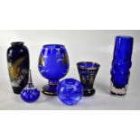 A group of blue glassware to include a large decorative blue glass brandy glass with gilt lily