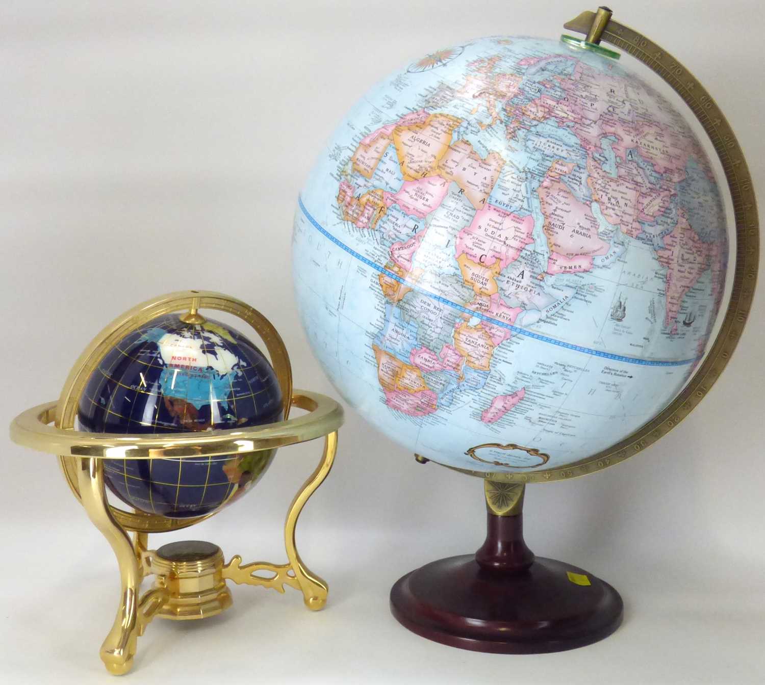 Two modern globes comprising a small agate and brass globe and stand, height approx. 27cm and a