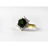 An 18ct yellow gold diamond and tourmaline ring, the claw set hexagonal cut green tourmaline