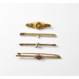 Four Victorian and Edwardian bar brooches comprising a 15ct yellow gold bar brooch with central